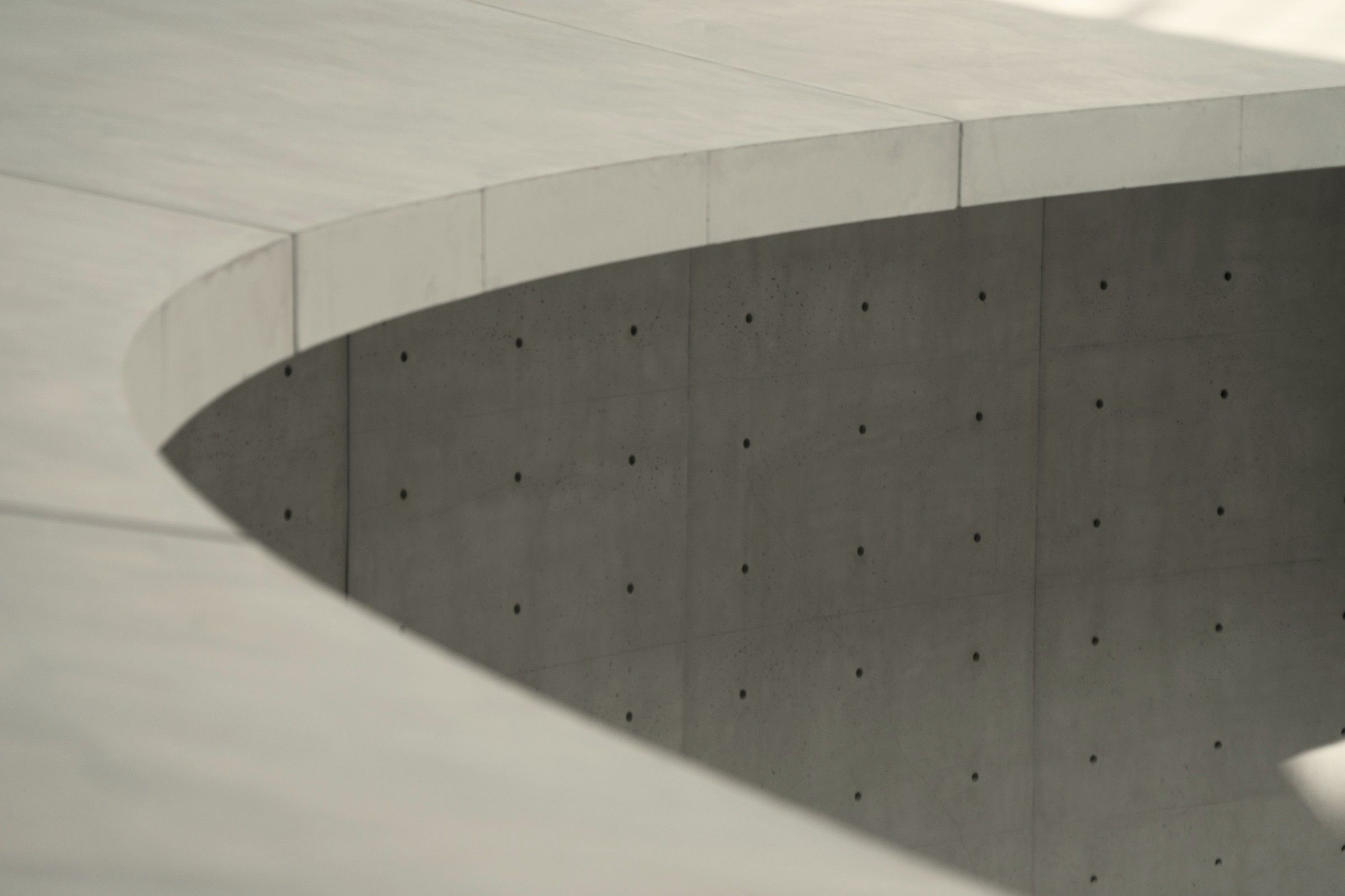The curved edge of a concrete structure